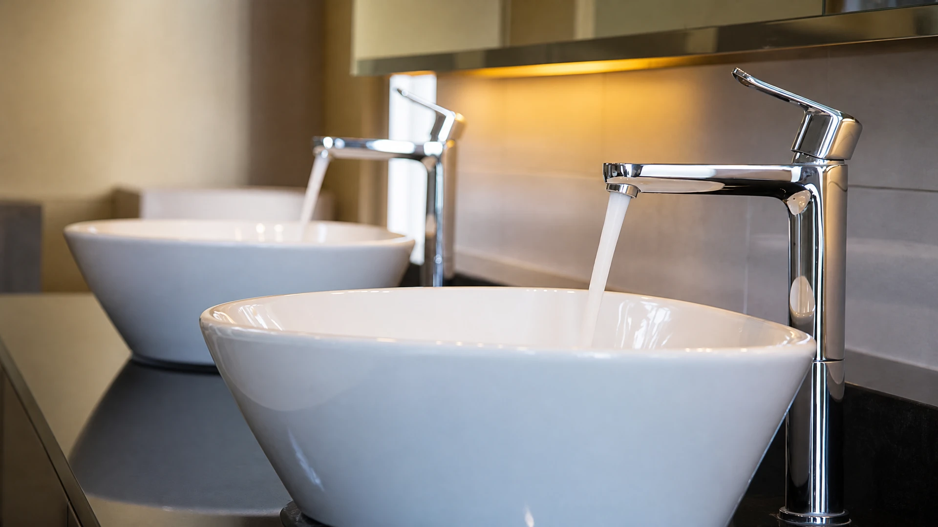 Intérieur cuisine moderne, mains installant flexible d'alimentation sous évier inox
